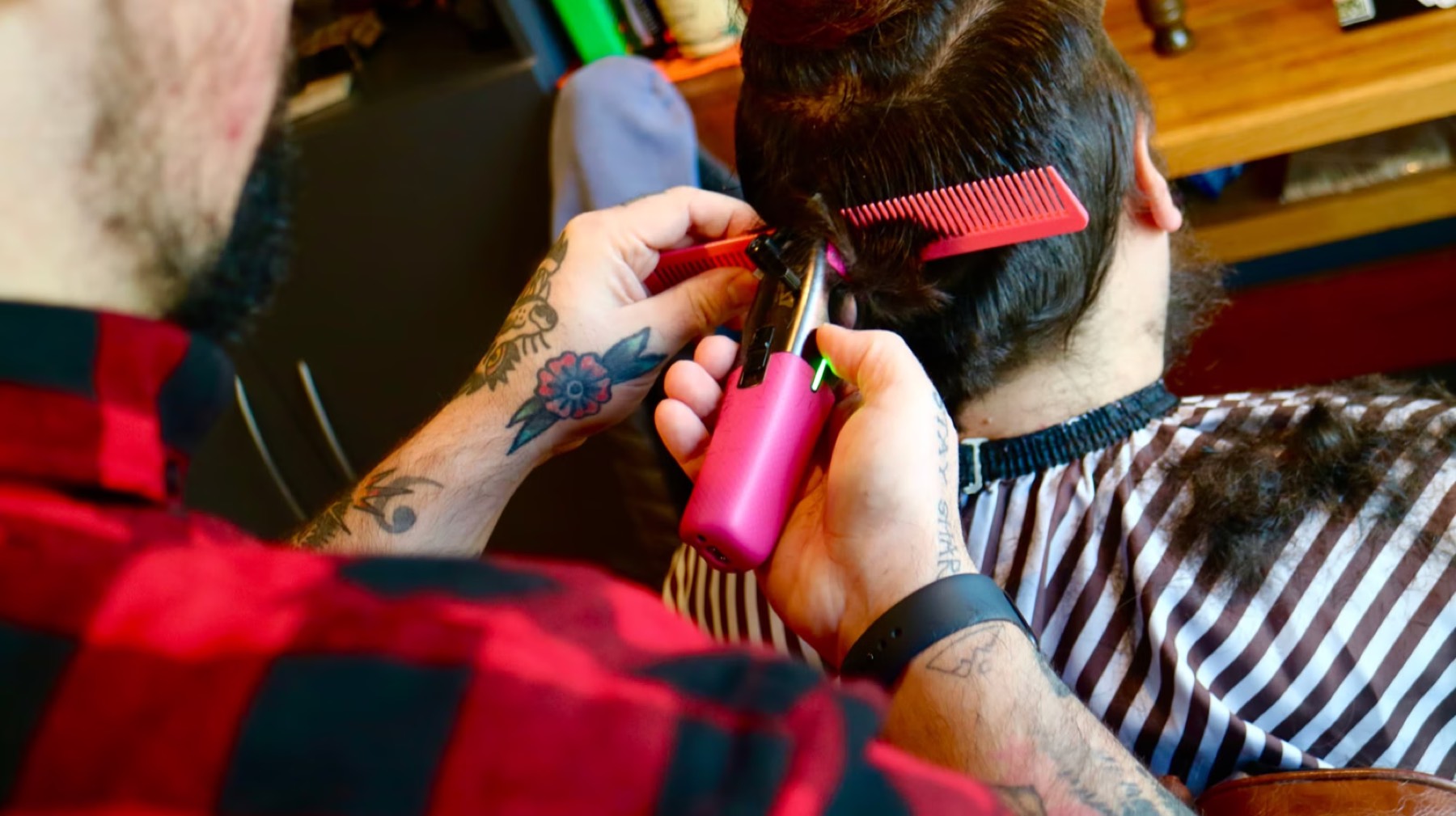 Barber styling client with precision tools